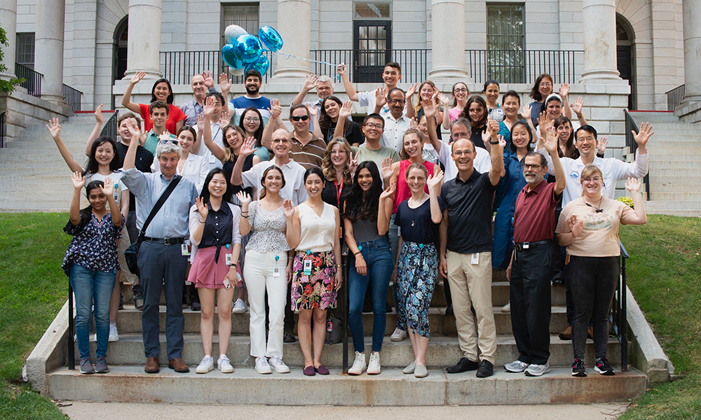 A couple dozen unit members pose together in front of a building. A couple dozen unit members pose together in front of a building.